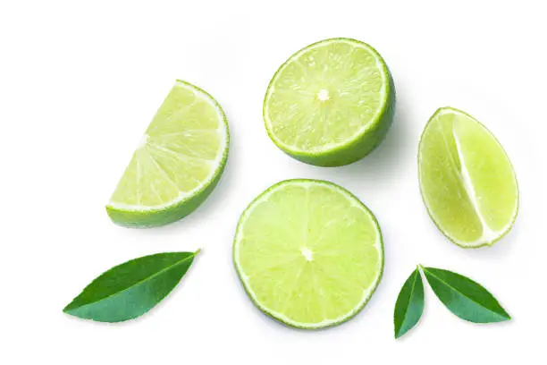Slice of green lime fruit with green leaf isolated on white background. Top view. Flat lay. Copy space for text.