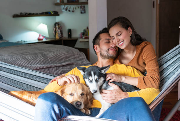 istock couple with their pets in the room. 1369575405