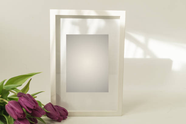 istock White wooden picture frame tulips. 1369576663