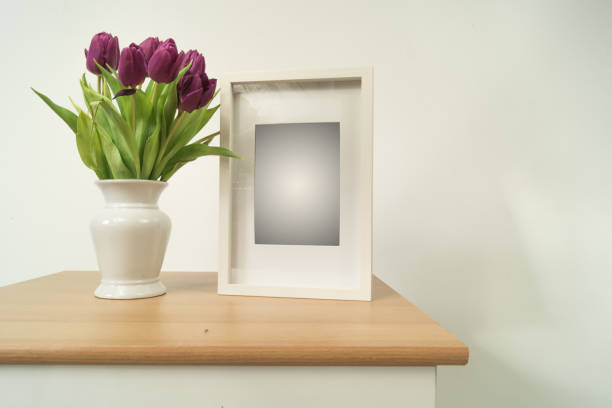 istock White wooden picture frame tulips. 1369576680