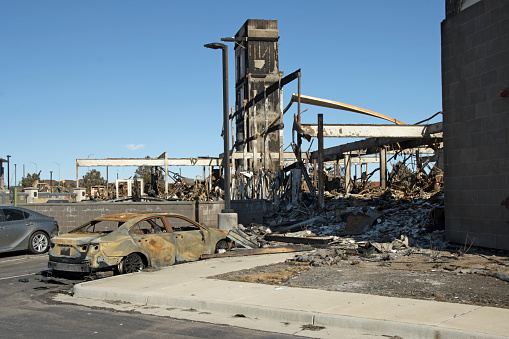 Just off Interstate 36, a charred car sits in front of elevator shafts at the burnt out remains of the newly built Element Westin hotel which was leveled by fire and wind from the Marshall fire on on December 30, 2021.