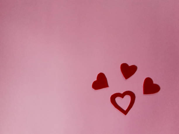 istock On a pink background, red hearts made of felt, empty copy space, creative idea for a layout 1369578477