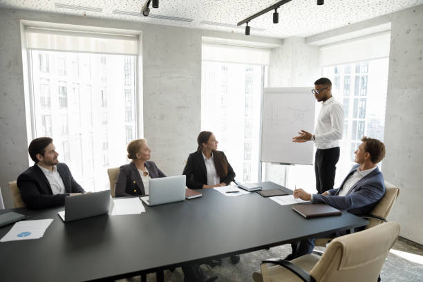 istock Confident African American business team leader speaking before audience 1369578618