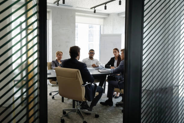 istock Candid shot of diverse team working together, discussing project 1369578647