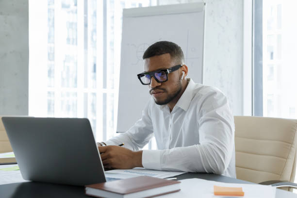 istock African business professional man with wireless earphone making video call 1369578660