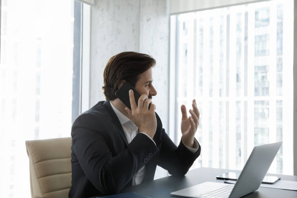 istock Happy business leader, executive talking on mobile phone at workplace 1369578709