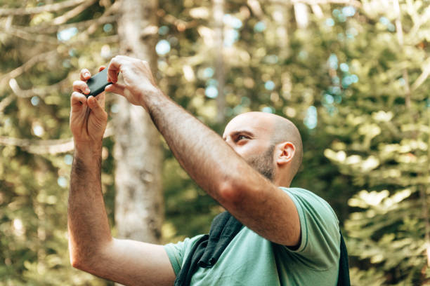 istock photographer in the forest 1369580257