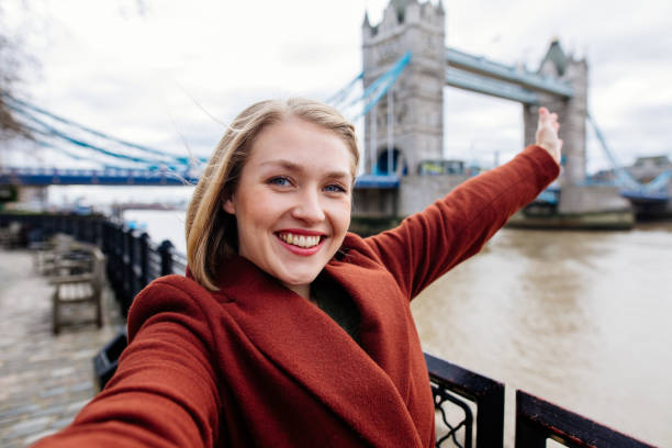 istock Young Woman Taking Selfie at Tower Bridge in London 1369580921