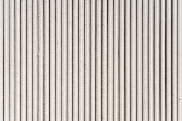 Modern corrugated concrete wall surface Close-up of a grooved concrete background texture. grooved stock pictures, royalty-free photos & images