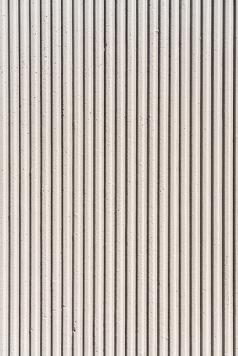 A newly finished surface of vertically grooved concrete wall.
