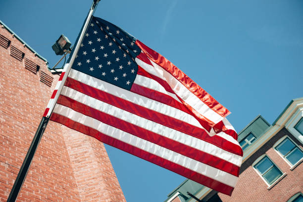 istock us flag waving on the sky 1369585890