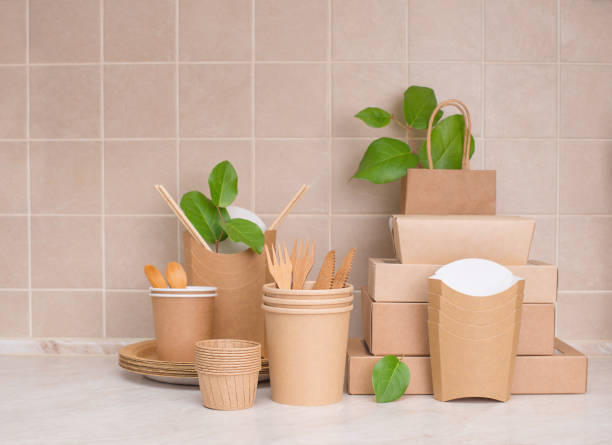 istock Eco friendly food containers from paper and branches with leaves on kitchen table. Plastic free. Zero waste. 1369586136