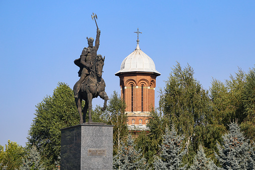 Michael the Brave Statue (Statuia lui Mihai Viteazul) and Holy Trinity Church in Craiova, Romania.