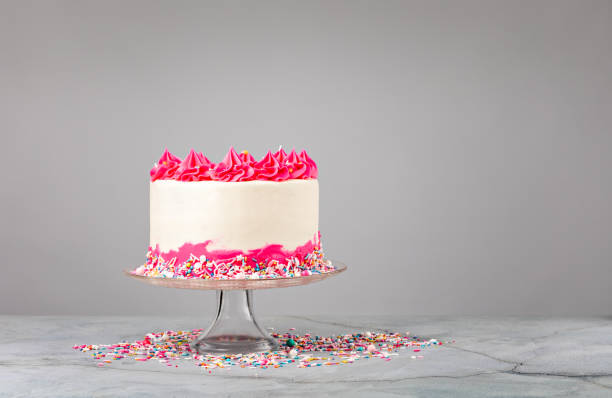 istock Pink Birthday Cake with buttercream icing and sprinkles 1369588540