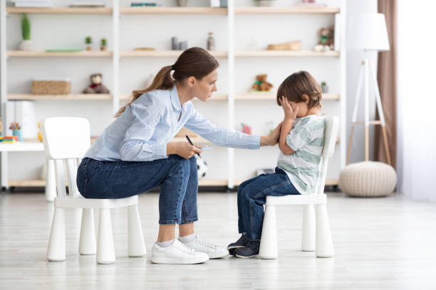 istock Upset little boy crying in psychologist's office unable to control emotions, sharing problems and traumas 1369589972