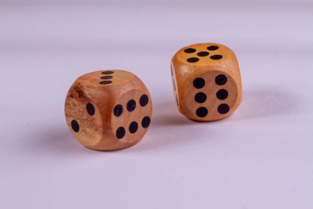 istock Two wooden dice isolated against a white background 1369590247