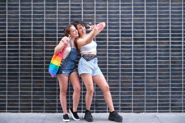 istock A lesbian couple taking a selfie with a smartphone. 1369590317