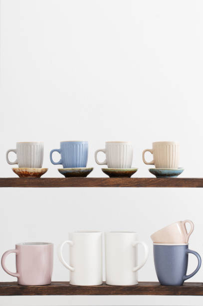 istock colorful cups on  wooden shelf on  white background 1369591578