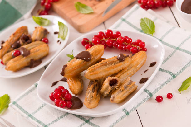 istock Mini churros with chocolate dipping sauce. 1369593031