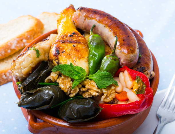 Bulgarian dish Kapama National festive Bulgarian dish Kapama - stew from several types of meat and sausages with stuffed vegetables served with greens and walnuts kapama reserve stock pictures, royalty-free photos & images