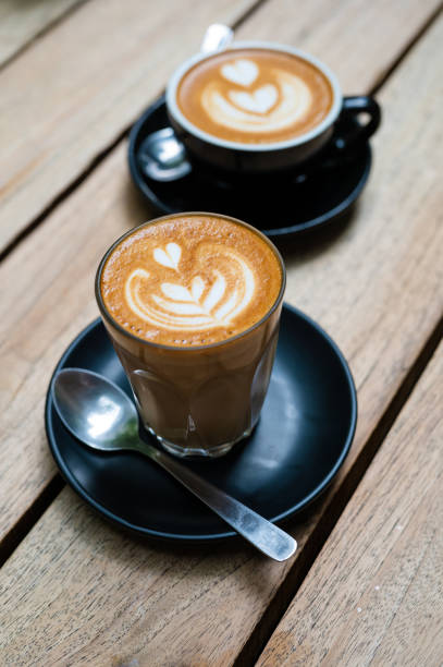 istock Hot cappuccino white coffee cups with heart shape latte art 1369596179