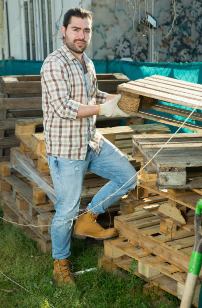 istock Man working with wooden pallets 1369596243