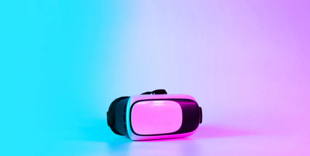 istock VR headset virtual reality. 3d digital glasses on futuristic neon tech background. Innovation device, cyberspace technology. 1369597542