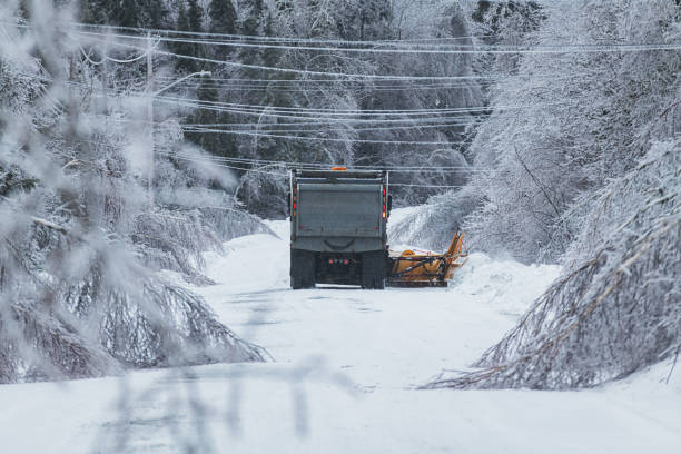 istock Snowplow Clears Road During Ice Storm 1369598682