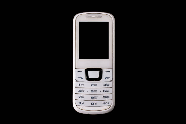 istock Old cell phone isolated on black background. 1369603242