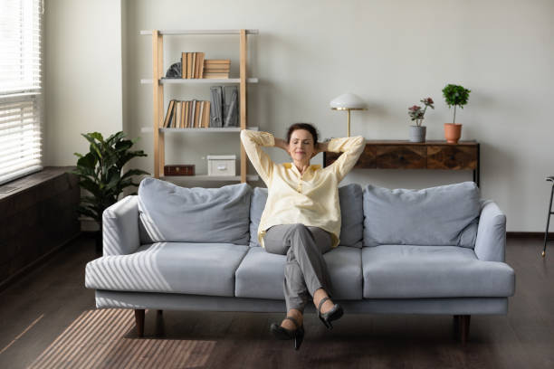 istock Happy peaceful middle aged woman sleeping on cozy couch. 1369604086