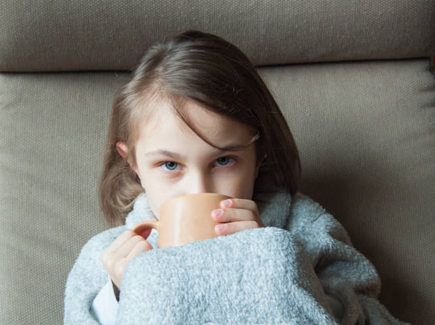 istock A girl drinks cocoa in a chair. 1369606336