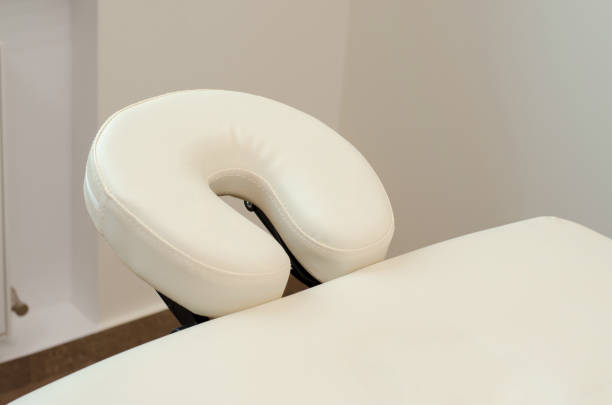 beige headrest on a massage table close-up. - massage table imagens e fotografias de stock