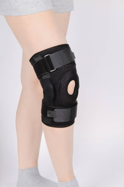 istock Knee Support Brace on leg isolated on white background. Elastic orthopedic orthosis. Anatomic braces for knee fixation, injuries and pain. Protective knee joint bandage sleeve. Trauma, rehabilitation 1369608623