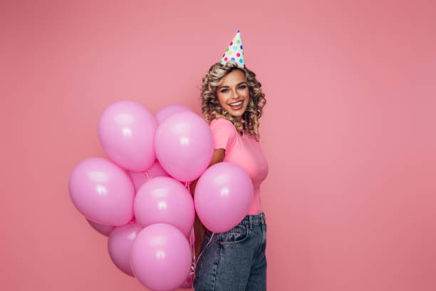 istock Happy beautiful woman with balloons 1369608844