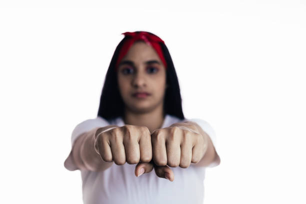 latin woman representing the concept of feminism in the studio with white background