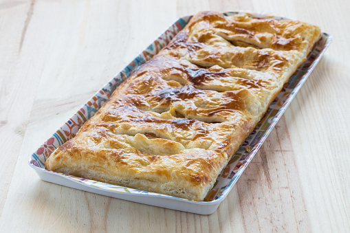 Delicious homemade puff pastry pie stuffed with apple and cinnamon