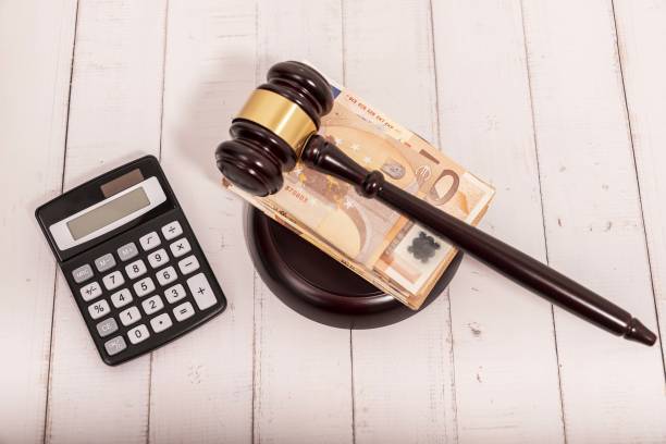 Compensation and judge's gavel. Award of moral financial compensation for caused damage. Lawyer services. Workers rights protection. Raising wages. Determination of payments by a court order. stock photo