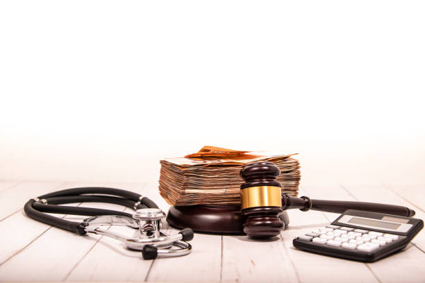 Compensation and judge's gavel. Award of moral financial compensation for caused damage. Lawyer services. Workers rights protection. Raising wages. Determination of payments by a court order. stock photo