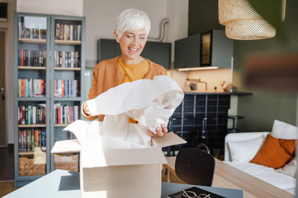 istock Senior woman unpack the package she ordered online 1369610118