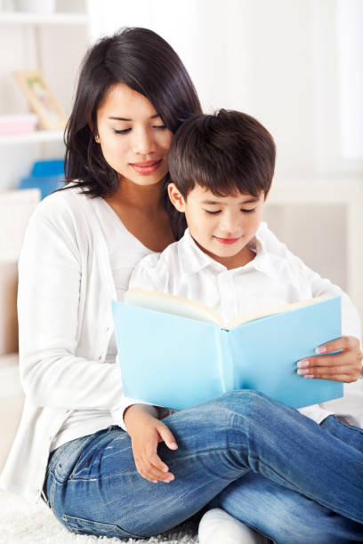 istock Mother and son reding together 1369610561