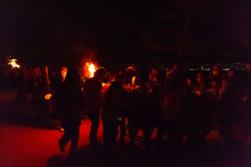Miyajima, Japan â December 31, 2019. Participants of the Chinkasai Fire Festival at Itsukushima Shrine, near Hiroshima, carry large burning torches around the sea shore as part of a ritual to safeguard the island from fires.