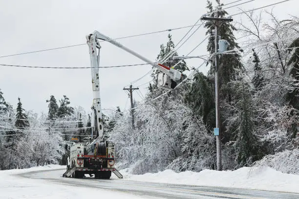 Linesman work to restore power during an intense ice storm.