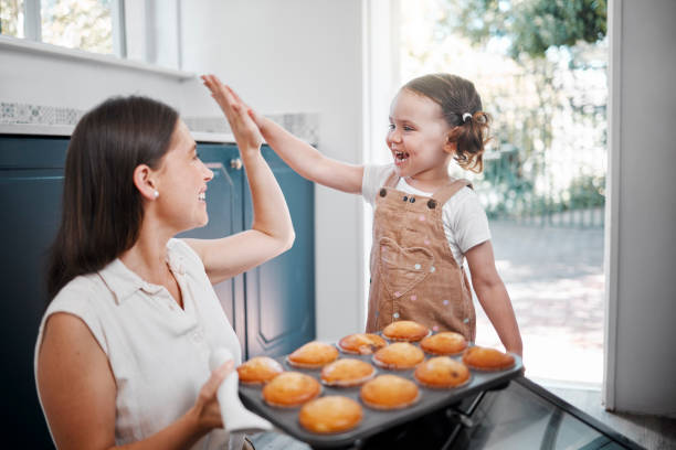 istock Shot of a woman sharing a high-five with her daughter while baking 1369613370