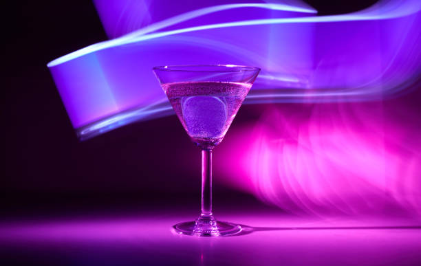istock Martini cocktail drink in neon iridescent pink and blue colors 1369614740