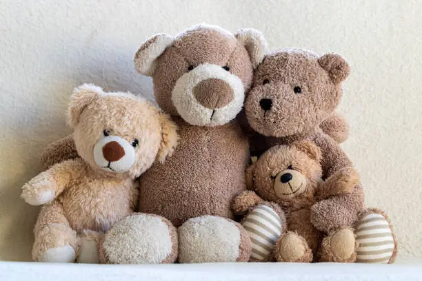 Happy teddy bear family (parents and two children) portrait