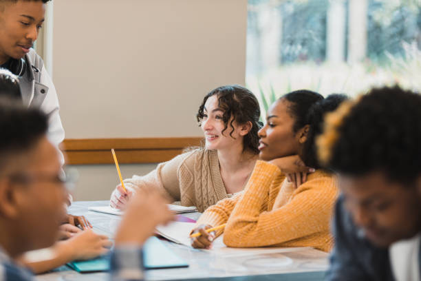 istock Diverse teenage students work together 1369617383