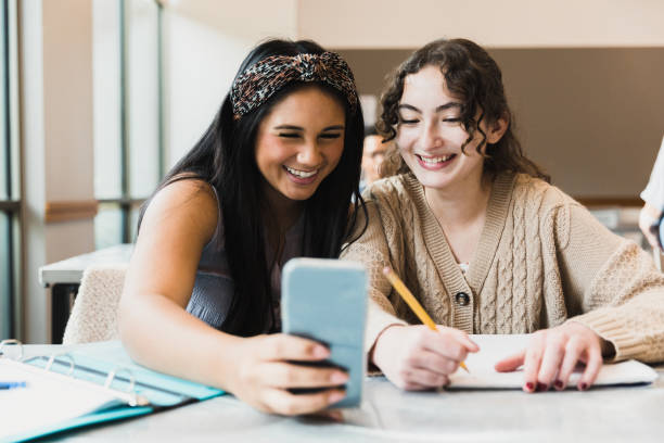 istock Two female teenagers take selfie during class 1369617404