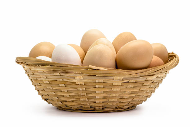 istock Brazilian free-range chicken eggs in rustic wooden bowl with white background and copyspace 1369617562