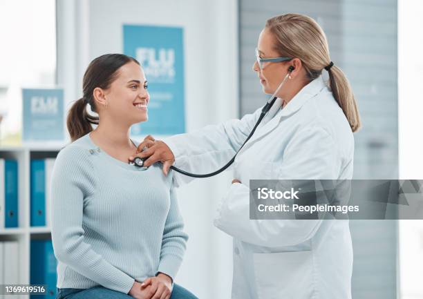 Shot Of A Doctor Examining A Patient With A Stethoscope During A Consultation In A Clinic Stock Photo - Download Image Now