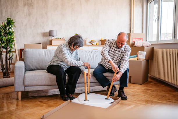 istock Senior couple assembling coffee table at their new home 1369620623